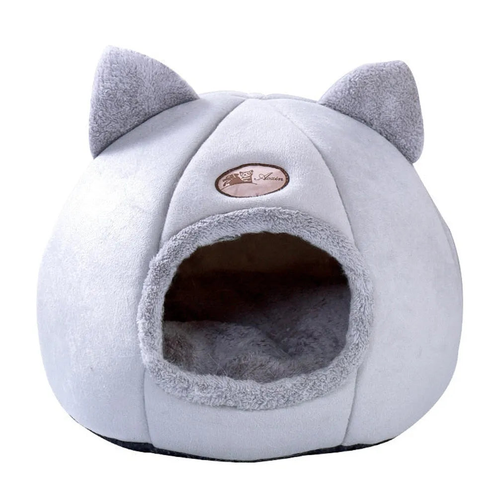 Large fully enclosed fabric cat house with a single entrance, shown in a home setting.