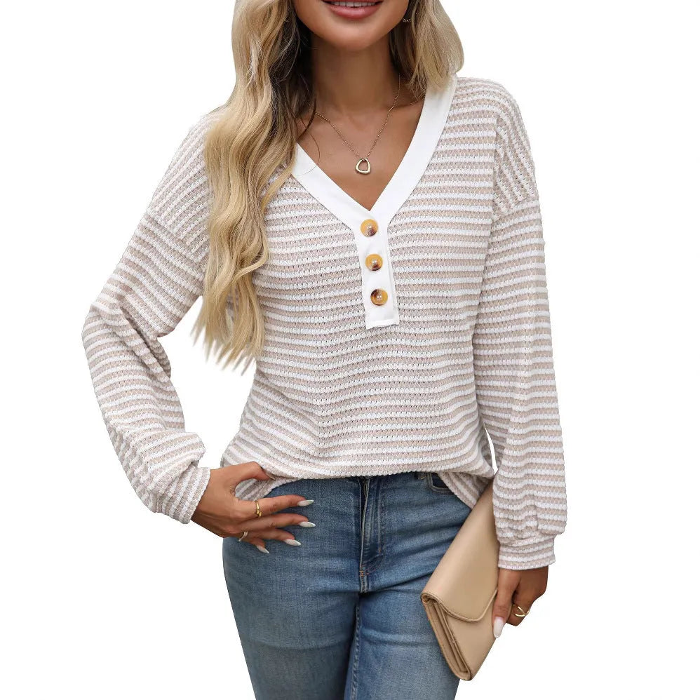 A woman's loose-fitting V-neck pullover top with long sleeves and patchwork detailing.