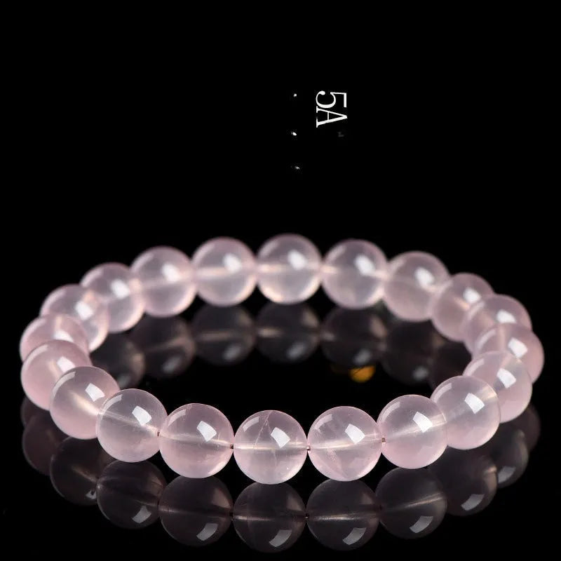 Natural crystal round beads bracelet with hand-polished finish in pink colour, showing seven size options from 6mm to 22mm diameter