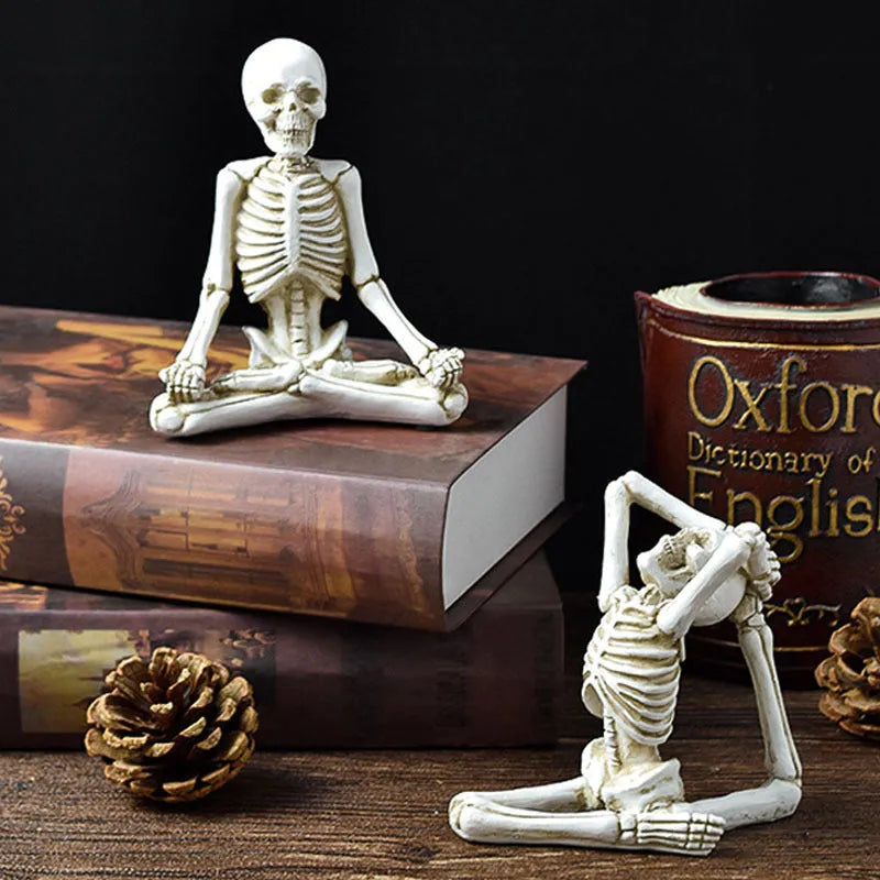 Hand-painted resin yoga pose skull skeleton ornament measuring 10.5-11cm wide on wooden desktop