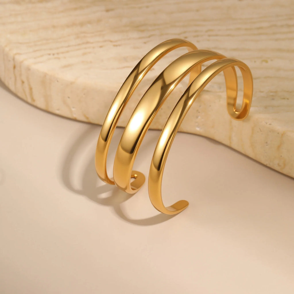 Stainless steel simple opening bracelet with geometric line design in gold or steel electroplated finish