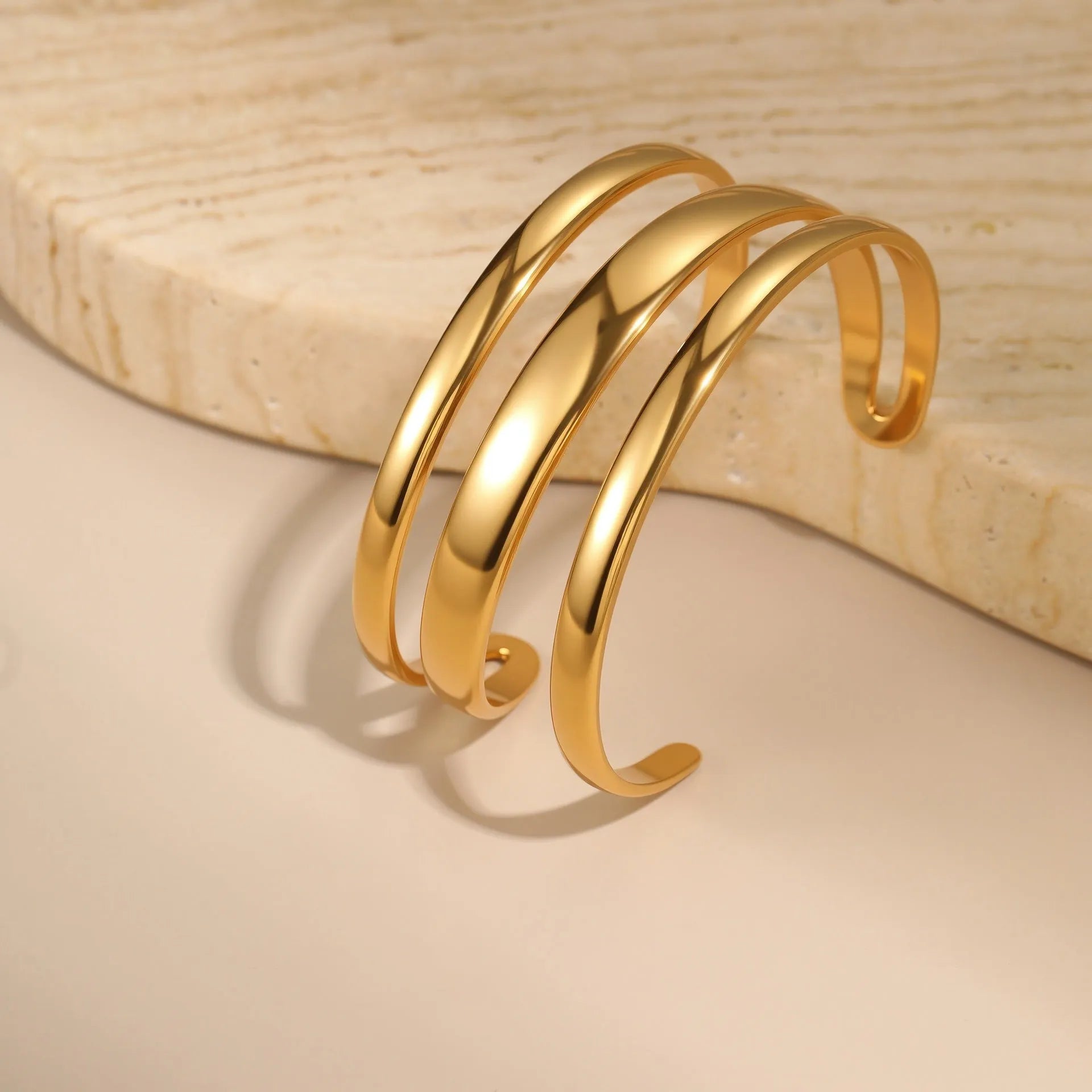 Stainless steel simple opening bracelet with geometric line design in gold or steel electroplated finish