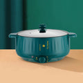 Stainless steel electric pot with non-stick interior showing steaming, frying, boiling, and stewing functions