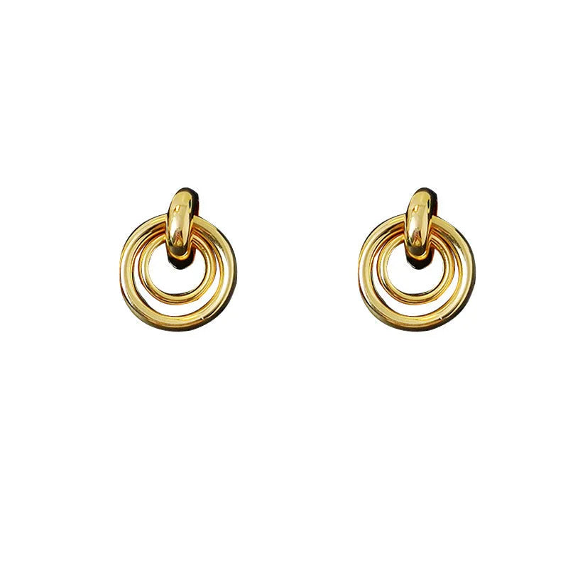 Geometric round ring earrings in gold or silver colour with irregular exotic styling