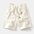 Men's khaki cargo shorts with multiple utility pockets, straight-leg design, and retro American-style detailing