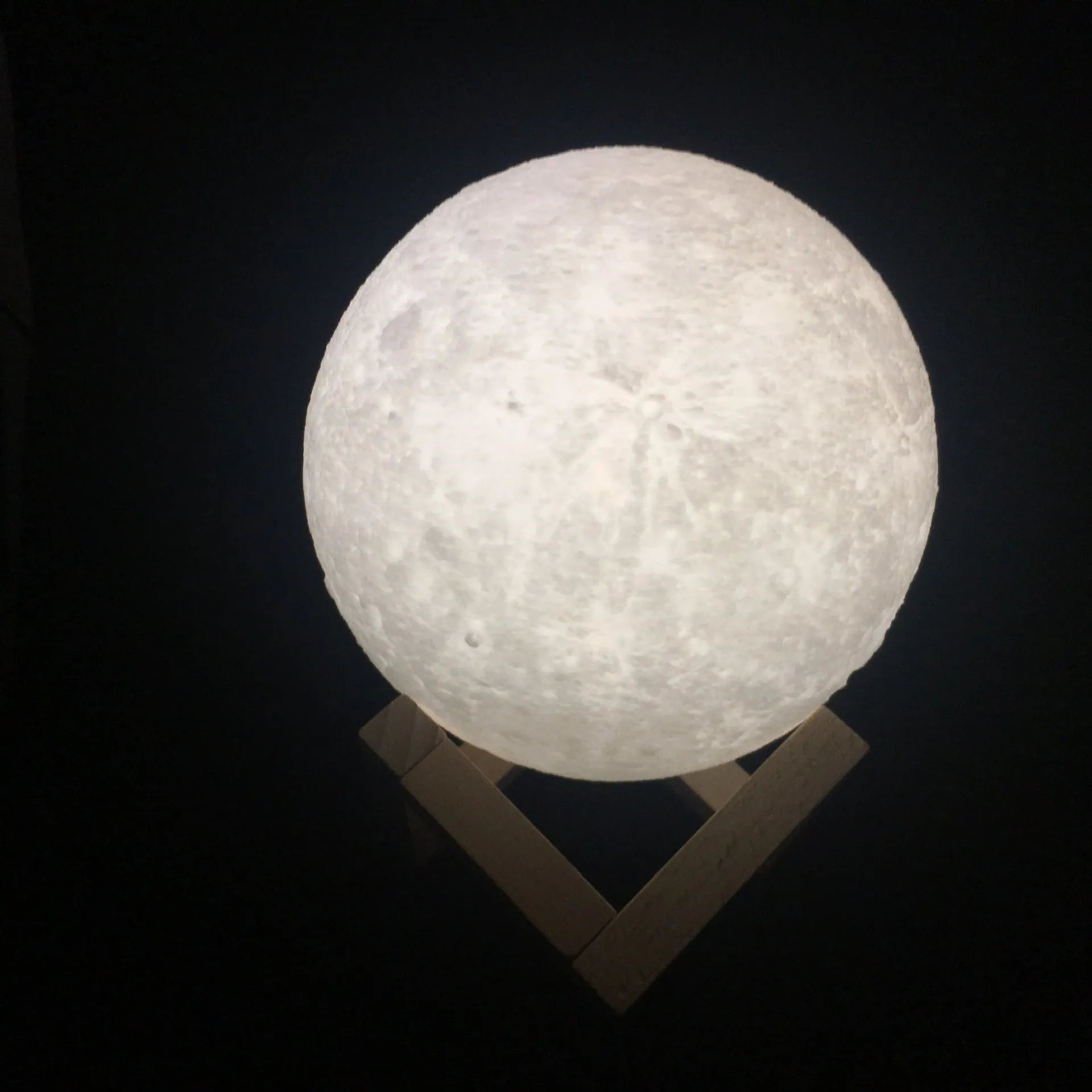 3D printed spherical moon lamp with visible surface contours and touch-sensitive metal ring at base