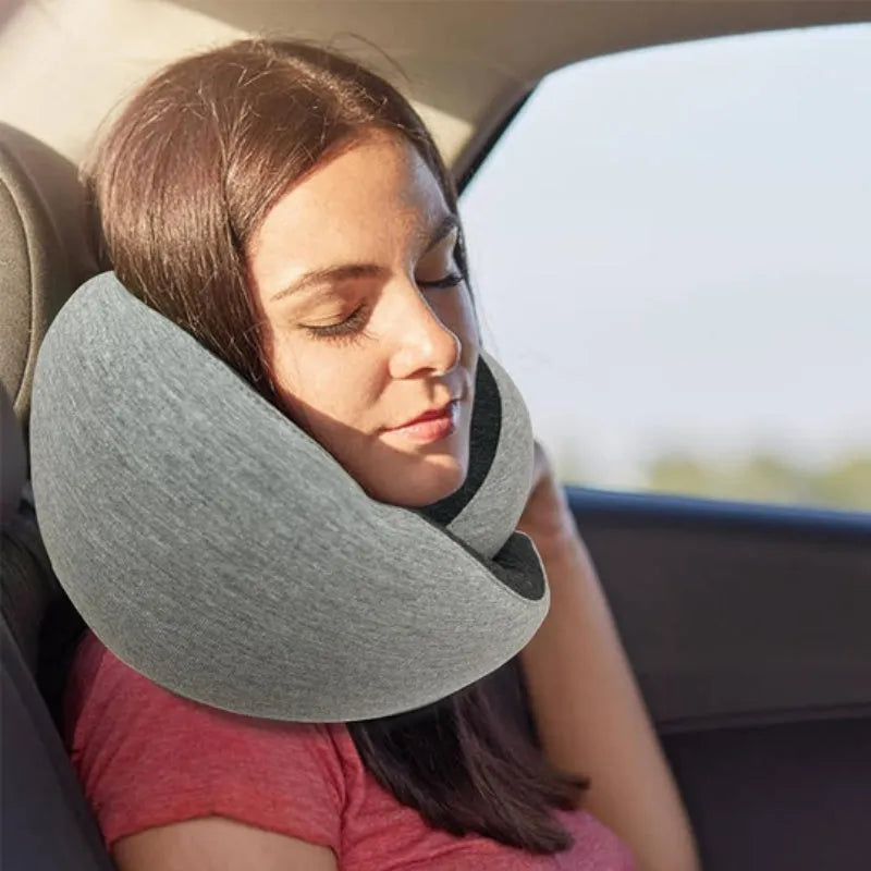 Navy blue U-shaped travel neck pillow with memory foam filling shown rolled and in its carry bag