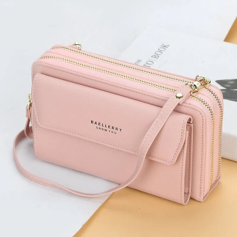 Red ladies long wallet with cross-body strap showing dual zippers and multiple internal pockets for organisation
