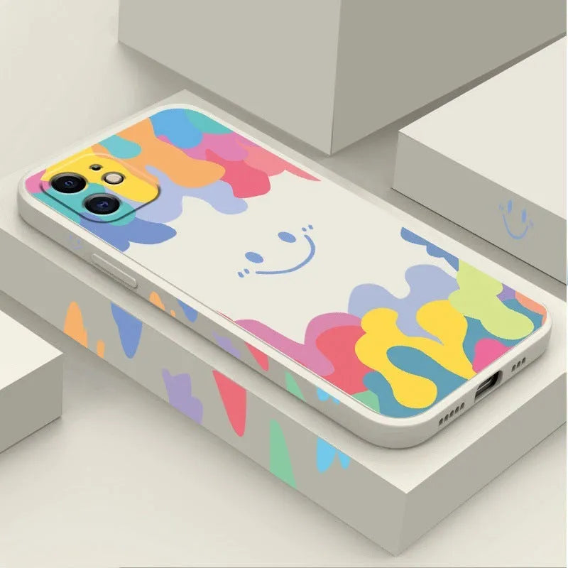White TPU phone case with rainbow smiley face design and attached black lanyard for Apple iPhone.