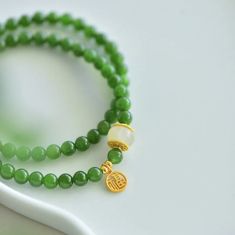 Women's double circle bracelet with natural Hetian jade beads and a central fu character charm.