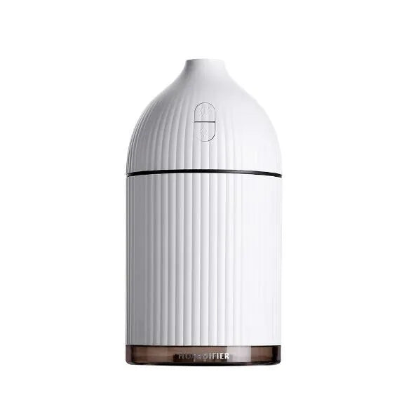 White ultrasonic aromatherapy diffuser with LED light, 300ml capacity, and USB cable on a wooden table