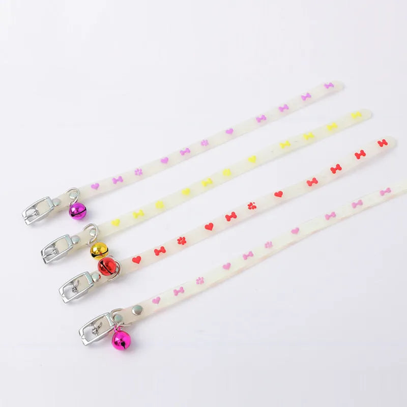 Luminous cat collar with a metal bell on an adjustable 29cm silicone strap, showing paw print design.