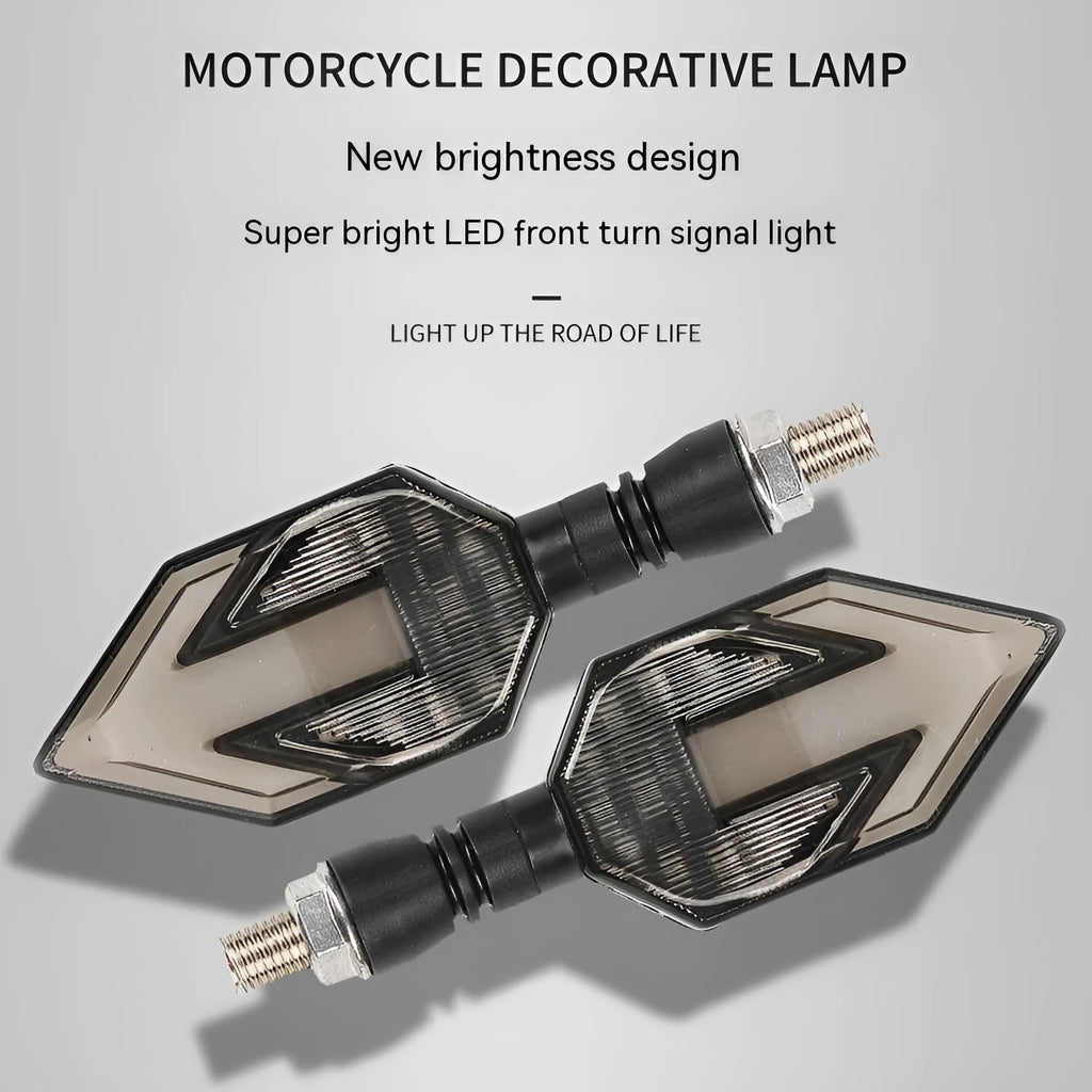 Arrow-shaped LED motorcycle turn signal lamp for 12V systems, made from black ABS plastic.