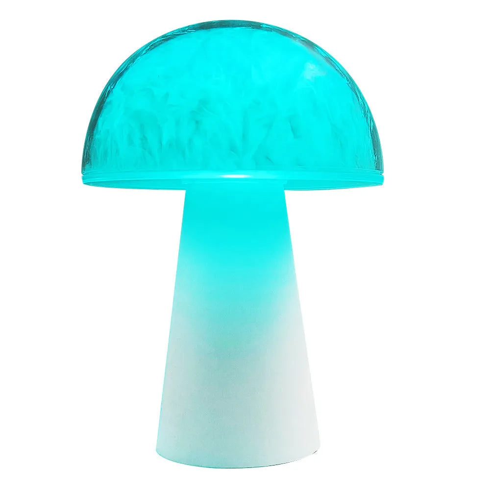 Colourful mushroom-shaped night lamp with remote control on a wooden surface.