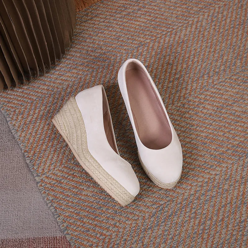 Women's apricot coloured wedge heel pumps with round toe and shallow mouth on a white background.