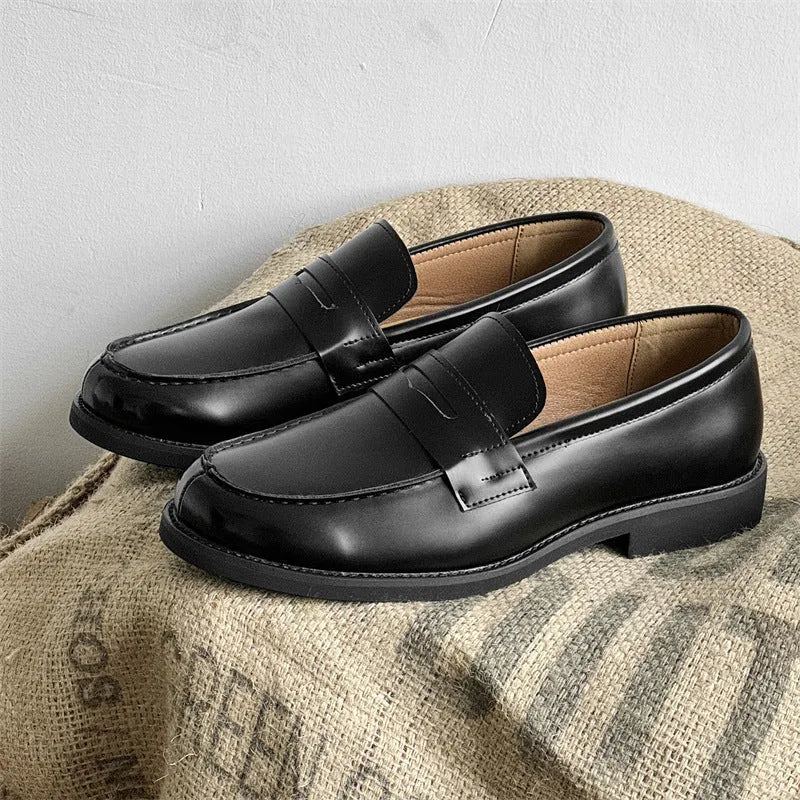 Black men's leather slip-on derby shoes on a white background