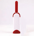 Blue reusable pet hair removal comb with double-sided flannel brush next to its self-cleaning base unit.