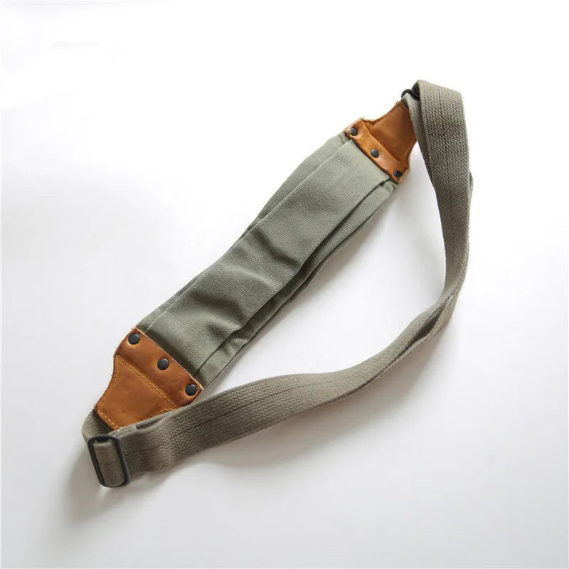 Green military style chest bag made from vintage canvas with cowhide leather accents and anti-theft design