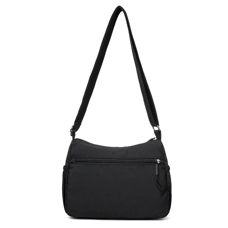 Soft water-repellent nylon crossbody bag in grey with a front 3D pocket.