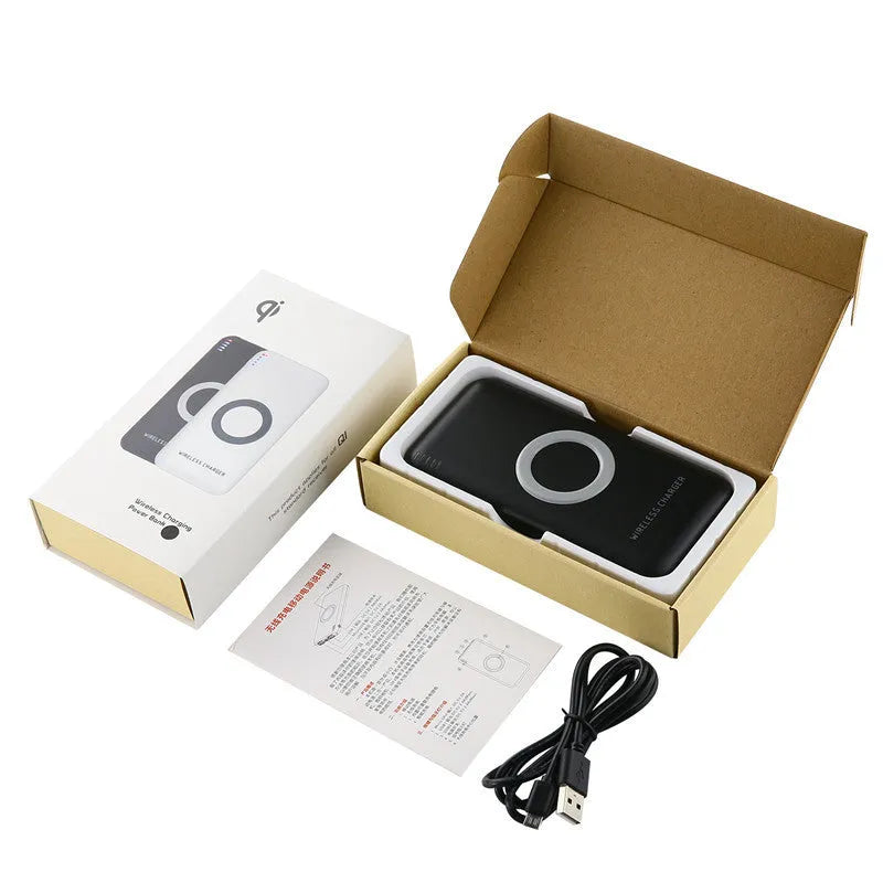 Black B100 wireless charging power bank on a wooden surface, showing USB port and charging indicator.
