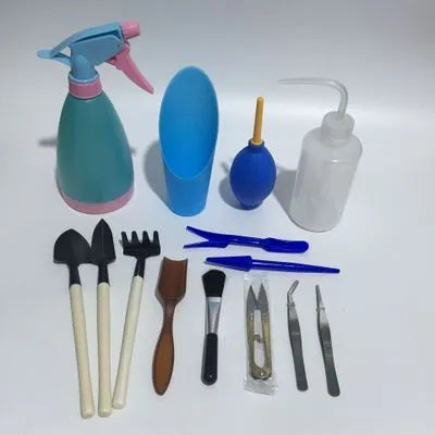 Succulent gardening tool set showing 14 implements including tweezers, watering can, and mini tools for plant care