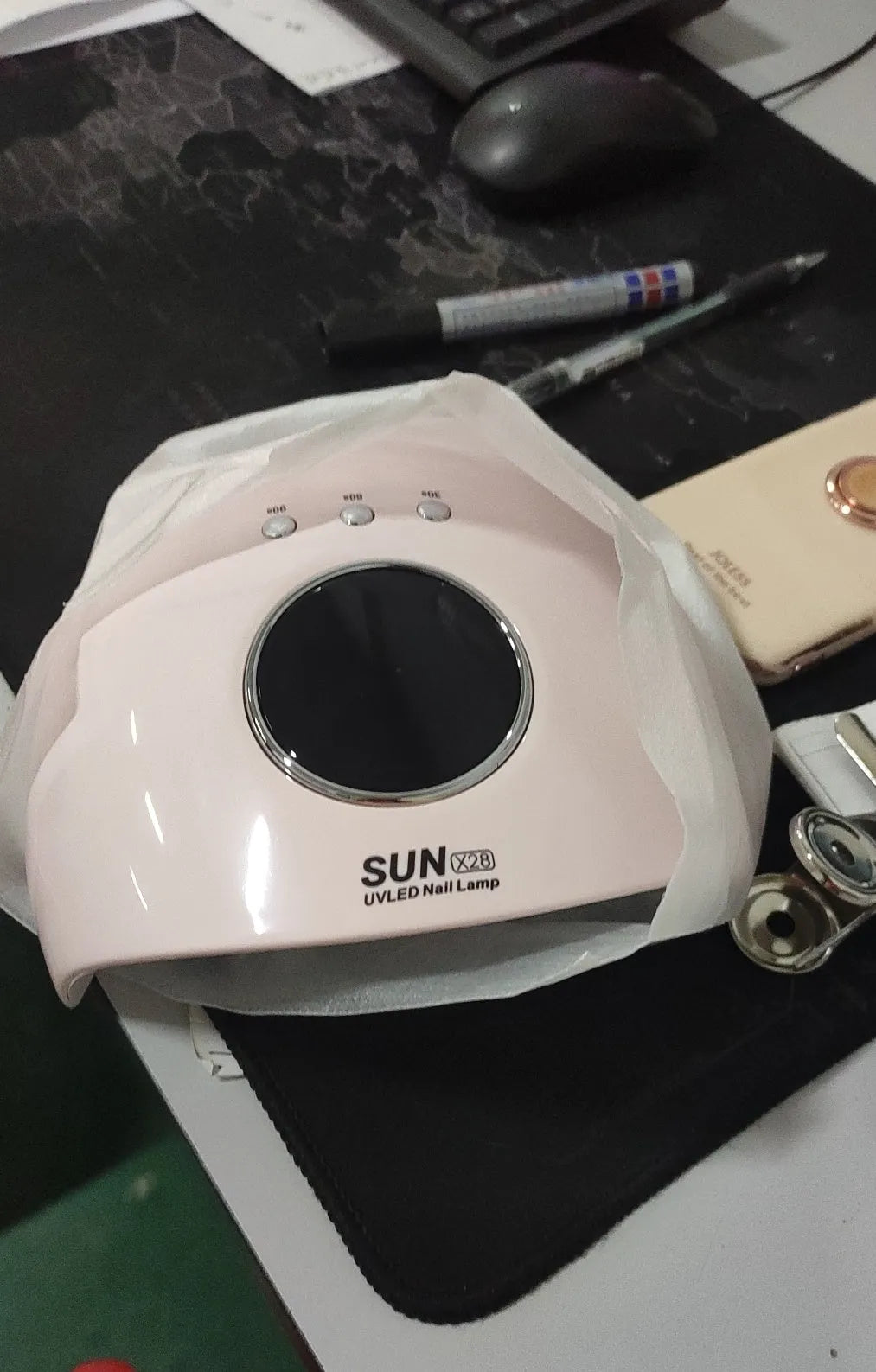 Manual card folding machine with a gold star-pattern cutting tool on a crafting table.