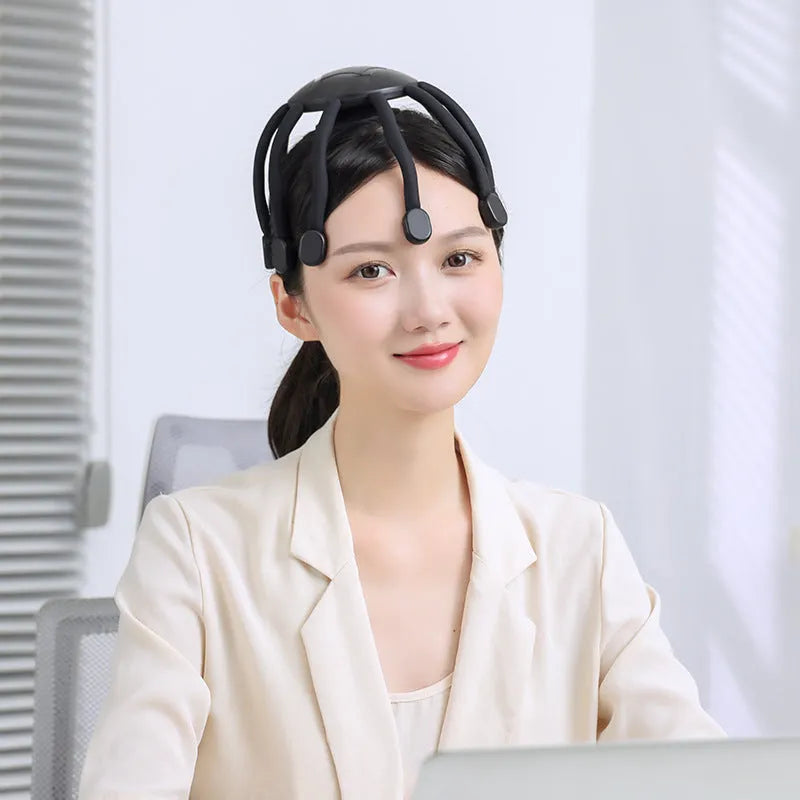 USB head massager with multiple vibrating claws in black or white colour options showing scalp placement