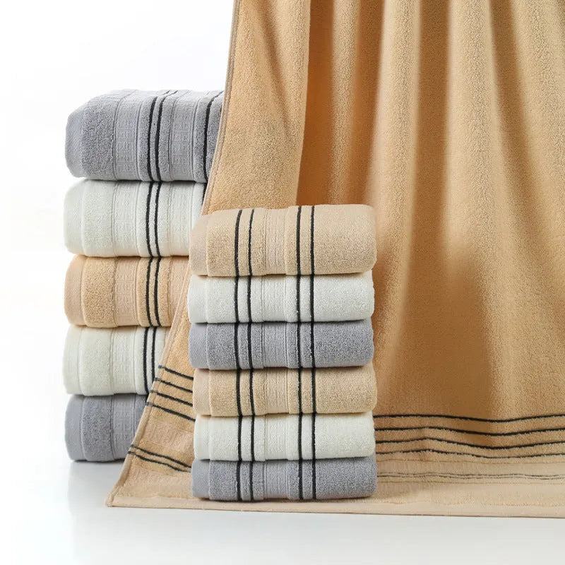 A set of one large bath towel and two smaller hand towels in a neutral colour, made from 100% cotton.