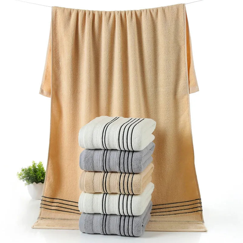 A set of one large bath towel and two smaller hand towels in a neutral colour, made from 100% cotton.