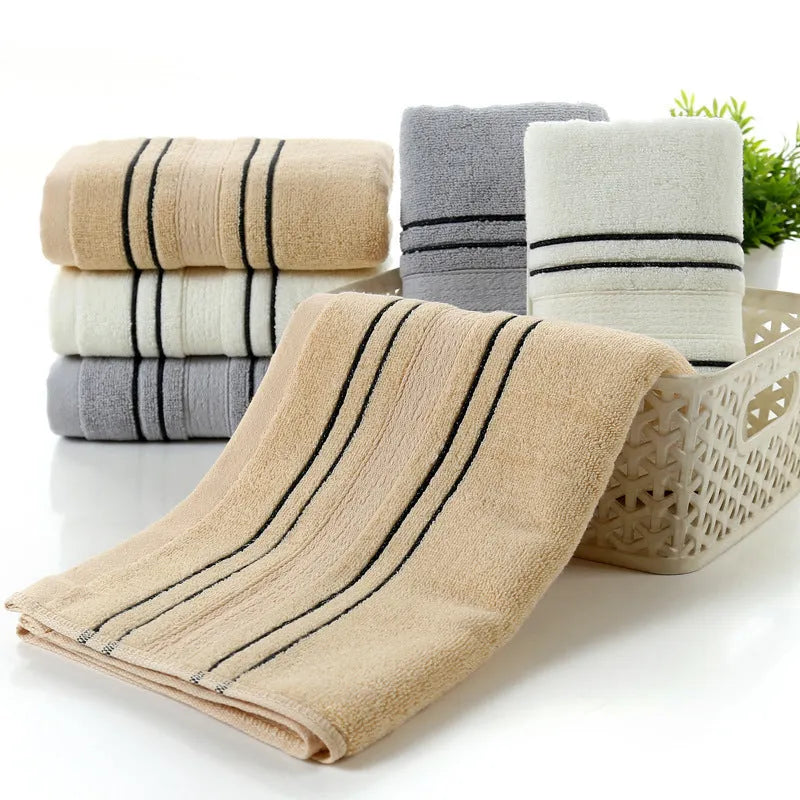 A set of one large bath towel and two smaller hand towels in a neutral colour, made from 100% cotton.