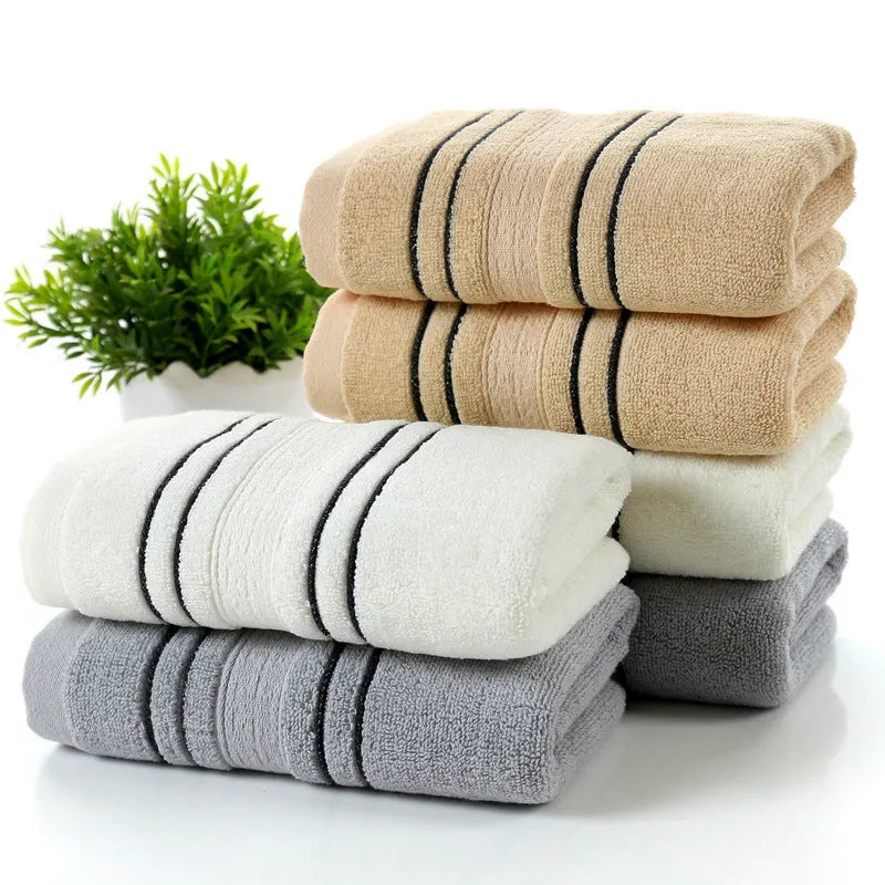 A set of one large bath towel and two smaller hand towels in a neutral colour, made from 100% cotton.