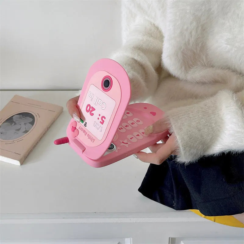 Flip phone shape mirror case for iPhone with silicone construction in light pink colour showing integrated mirror and flip cover design