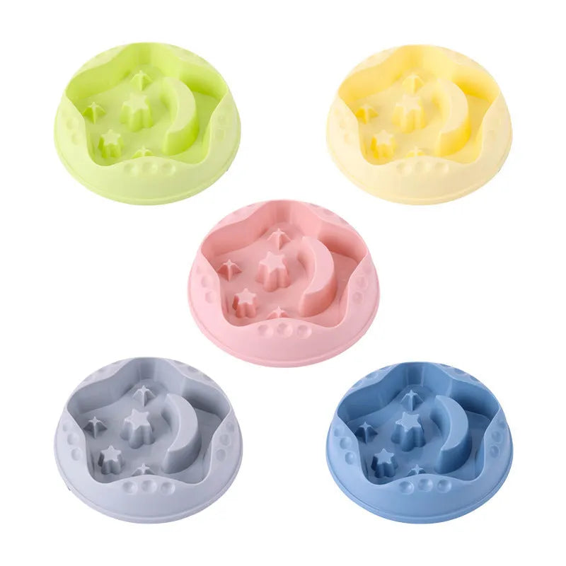 Moon star wings design slow feed dog bowl in blue, shown on a floor.