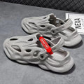Grey closed toe EVA coconut slippers for beach wear on a sandy background