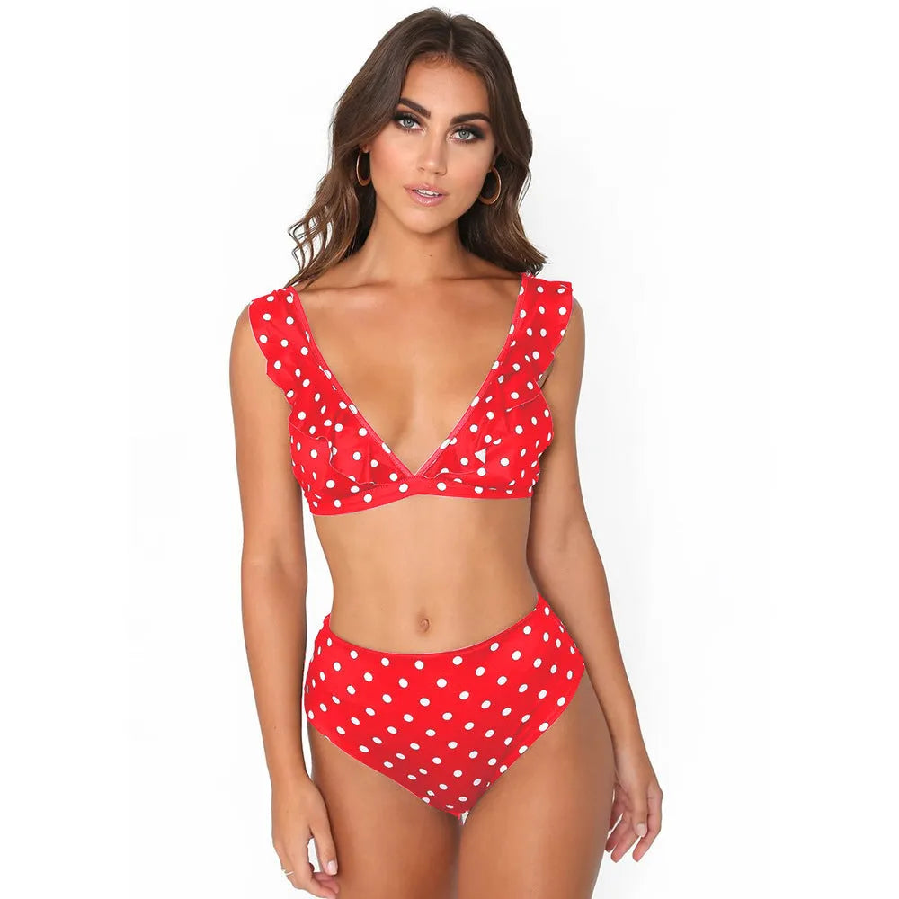 Women's black and white polka dot bikini set with deep V-neck top and ruffles