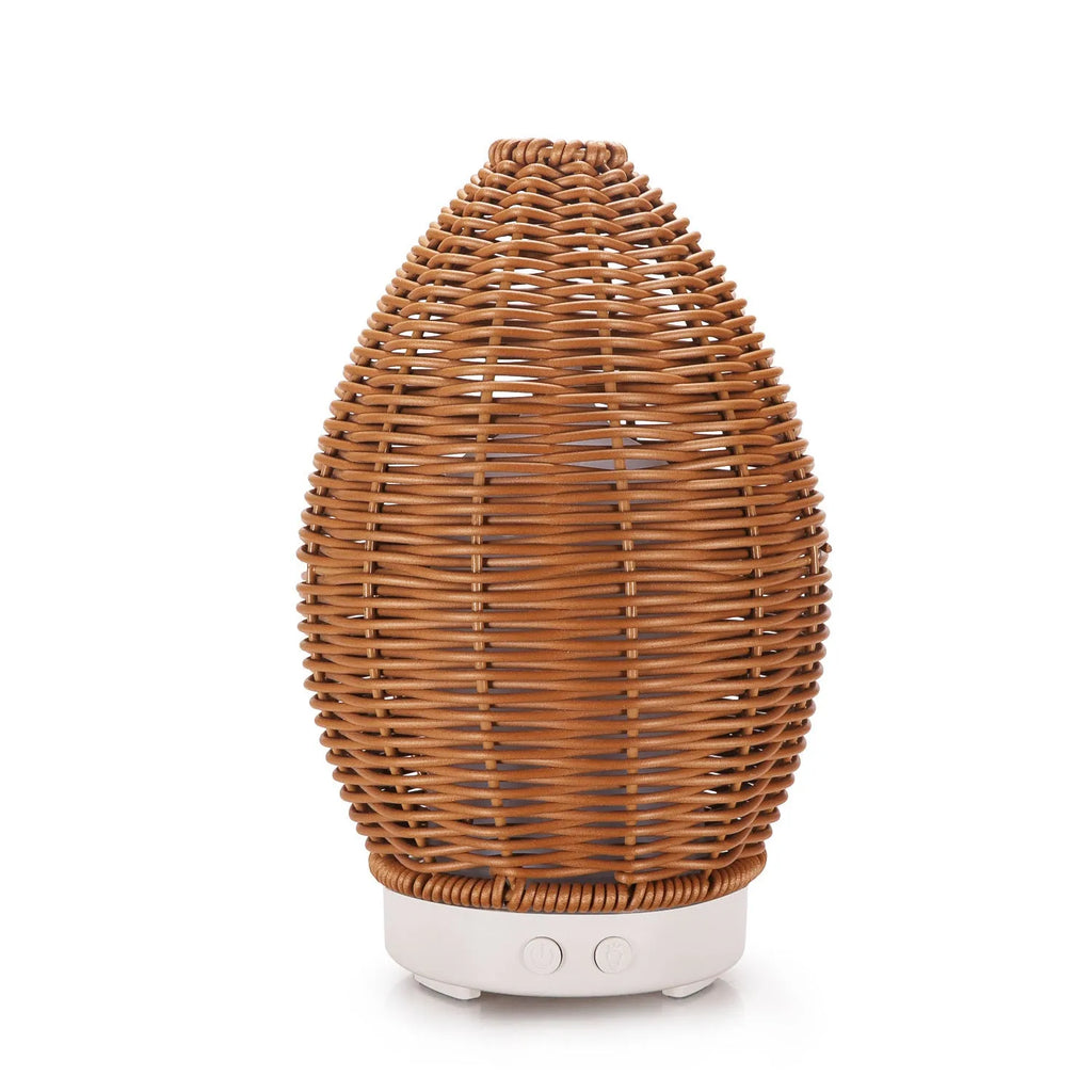 Light wood grain hollow rattan aroma diffuser with 100ml water tank on a wooden surface.