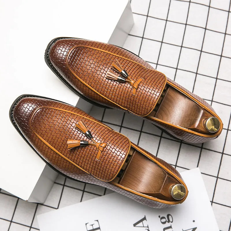 Men's black pointed slip-on leather shoes with tassel detailing on a low-top upper for business wear