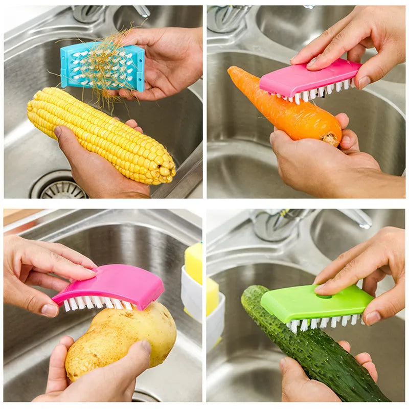 Coloured kitchen brush with knife and fork design and a white suction cup on its handle.