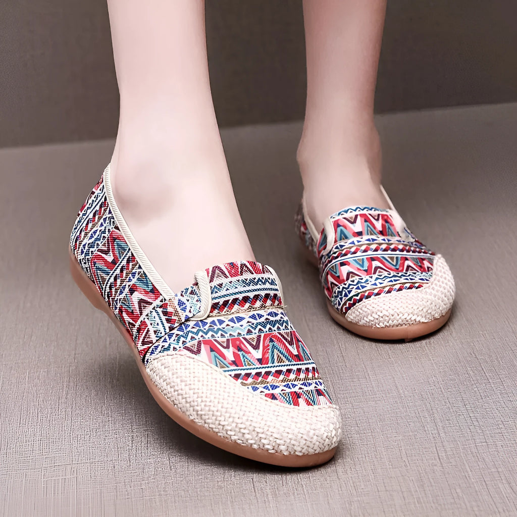 Women's ethnic style cloth shoes with flat heel, colour stitching, and a shallow mouth design.