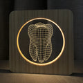 Tooth-shaped wood colour night lamp with USB cable on wooden surface