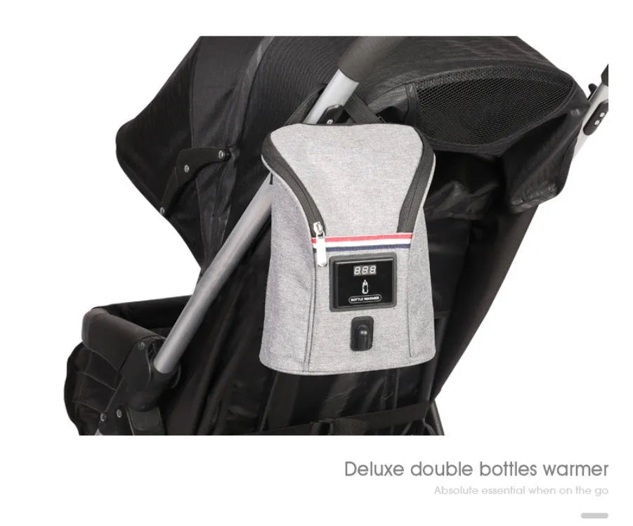 Grey portable baby bottle warmer with electronic display, car charger, and buckle for hanging on prams