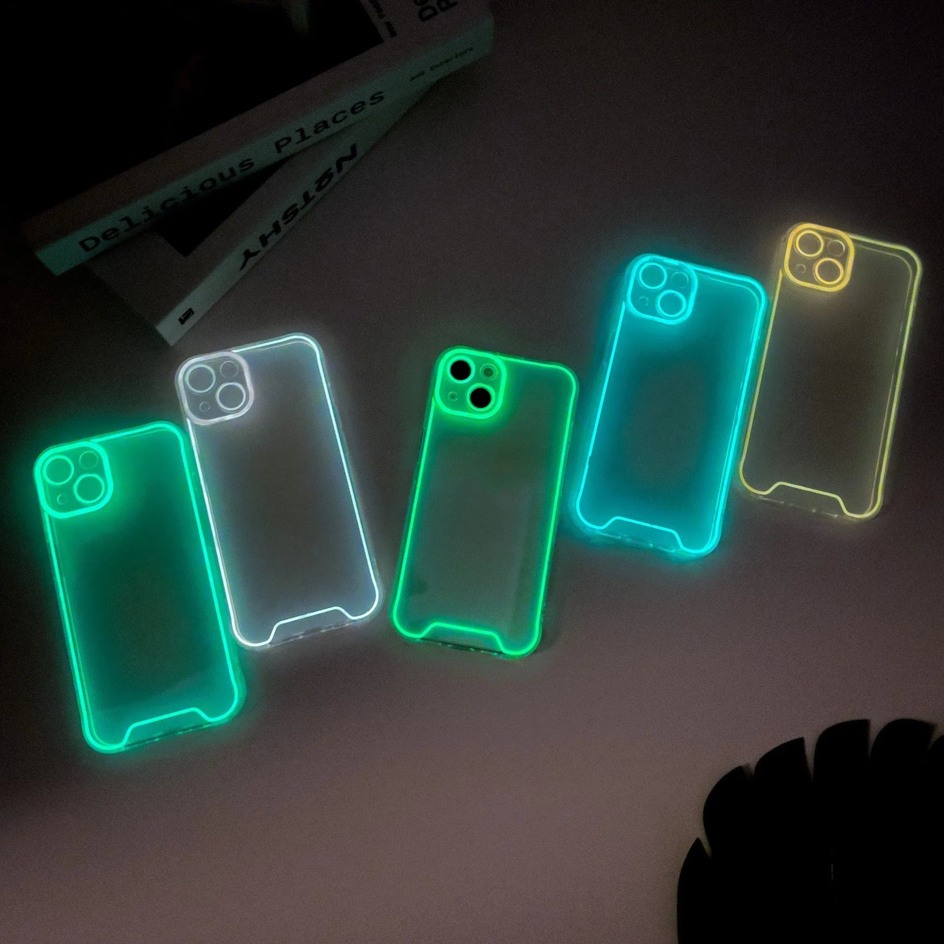 Glow in the dark Christmas phone case for Apple iPhone with soft TPU shell in green, orange, blue, yellow, and pink colours