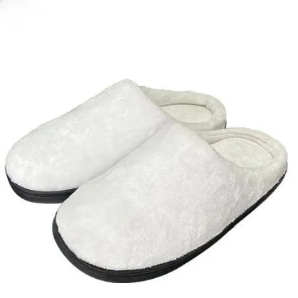 A pair of patterned cotton flannel slippers with a textured TPR outsole, shown on a wooden floor.