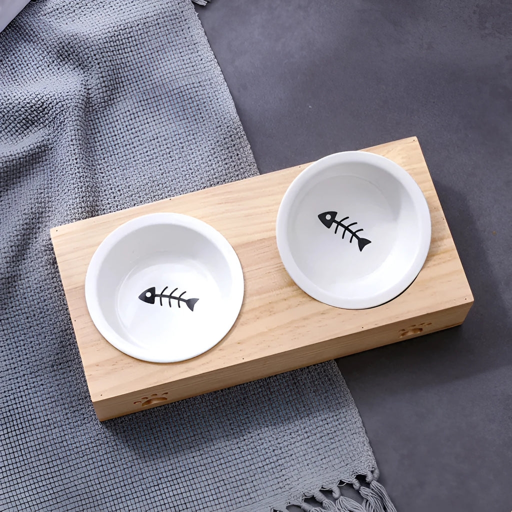 Solid wood pet dining table with stainless steel bowl inserts in a pine finish for dogs and cats.