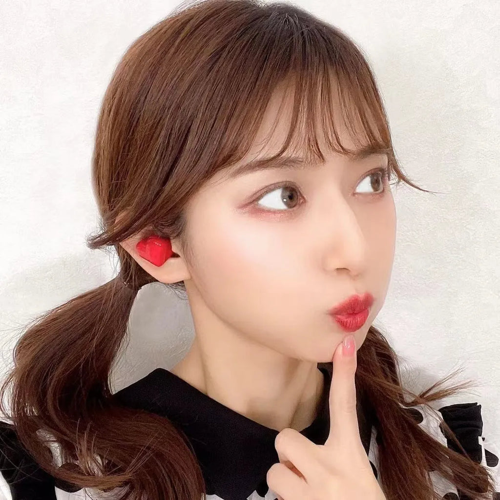 Heart-shaped wireless Bluetooth headphones in red or pink colour with charging cable
