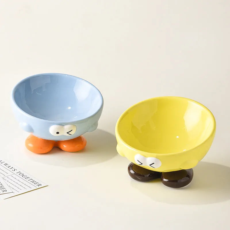 Blue slanted ceramic pet bowl for cats and dogs on a plain background.