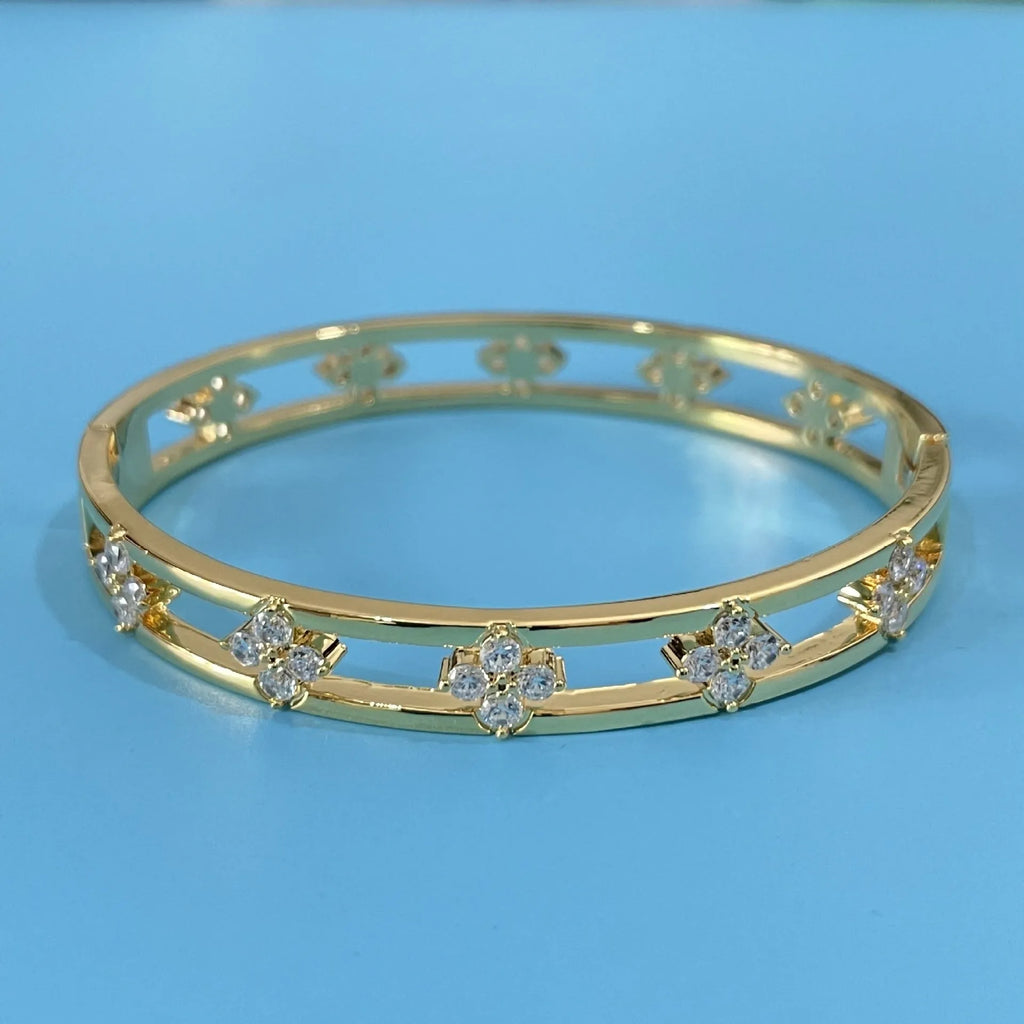 Gold and silver hollow women's bracelets with four-leaf clover charms and inlaid zircon detailing.