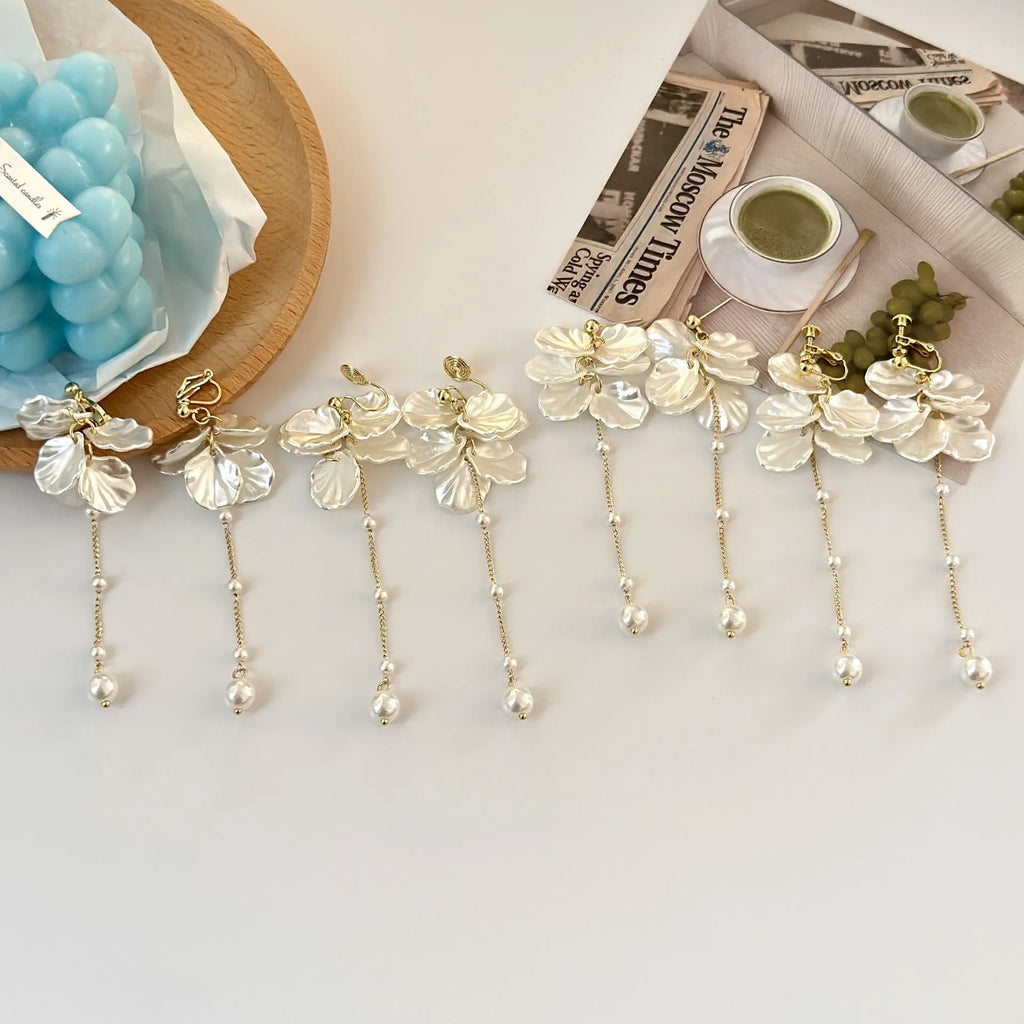Women's fashion earrings with shell pearl tassel design measuring 8.8cm long, showing clip fastening options