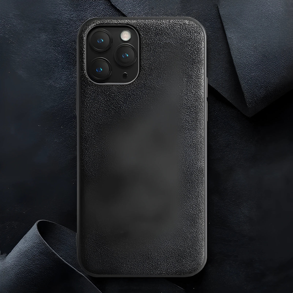 A luxury suede iPhone back cover in dark blue, shown fitted on a smartphone.