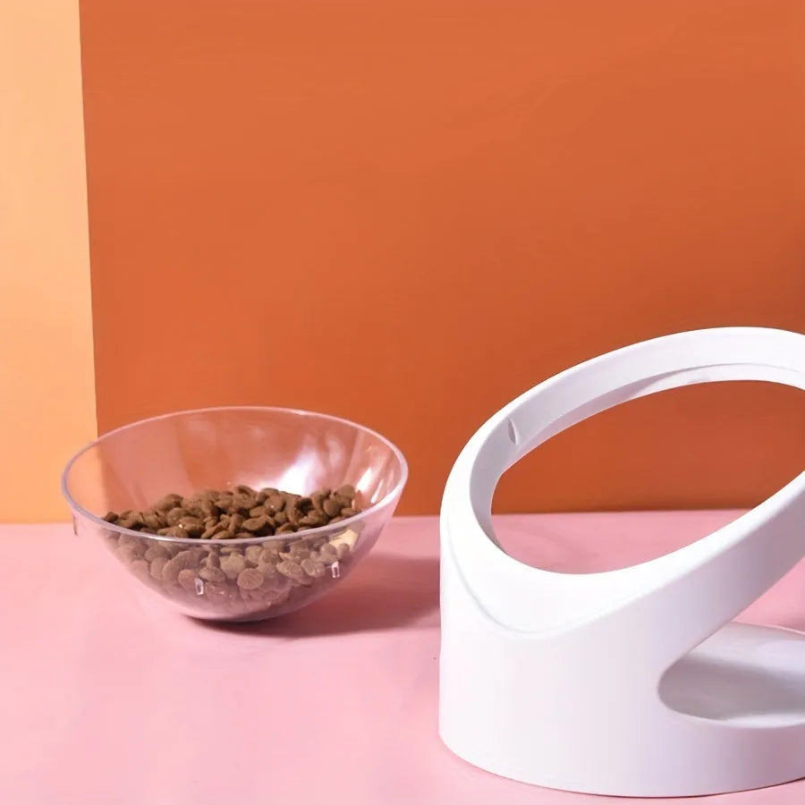 Clear elevated cat food bowl with 15-degree tilt angle on white surface